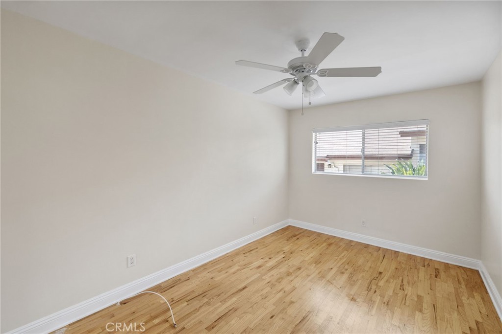 7137 Ramsgate Avenue Los Angeles, CA 90045 - Photo 12 of 14 an empty room with a window and ceiling fan