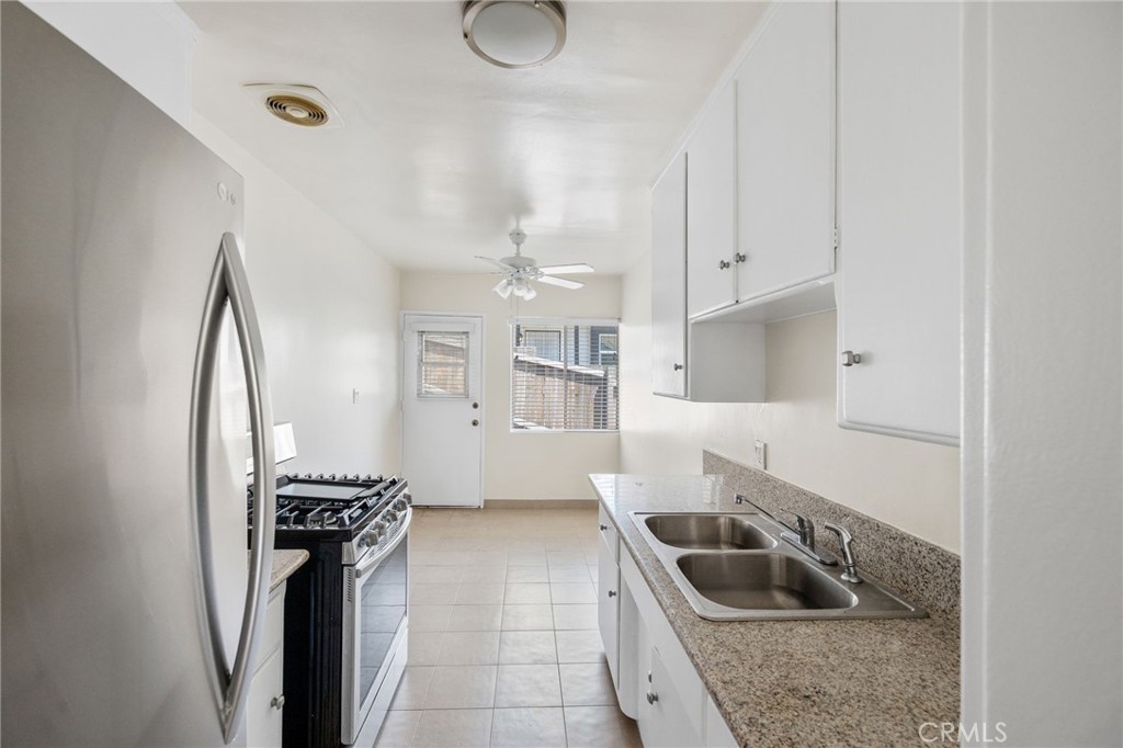 7137 Ramsgate Avenue Los Angeles, CA 90045 - Photo 5 of 14 a kitchen with a sink a stove and a refrigerator