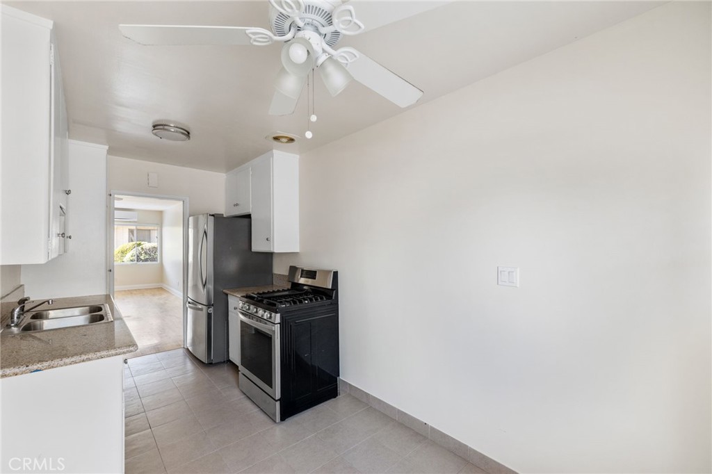 7137 Ramsgate Avenue Los Angeles, CA 90045 - Photo 7 of 14 a kitchen with stainless steel appliances a sink and a stove