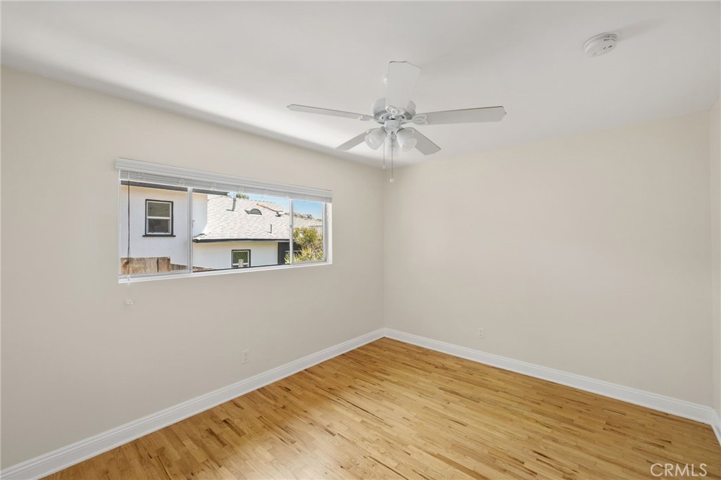 7137 Ramsgate Avenue Los Angeles, CA 90045 - Photo 9 of 14 a view of empty room with wooden floor and fan