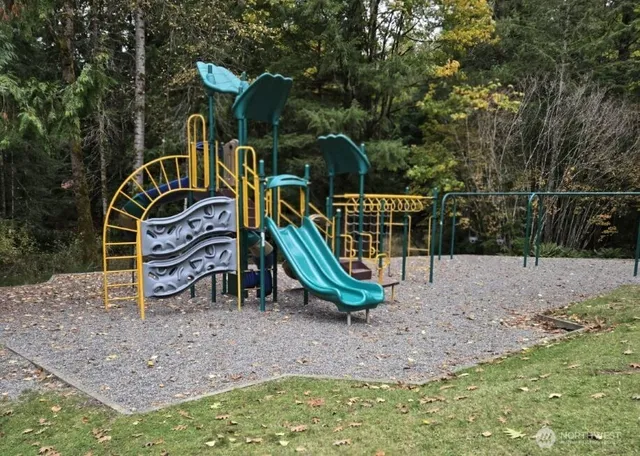 a childrens park with lots of swings and slides
