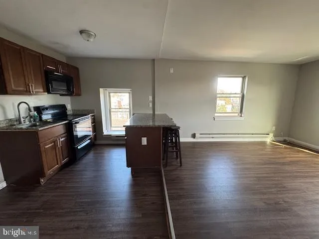 a kitchen with sink cabinets and wooden floor