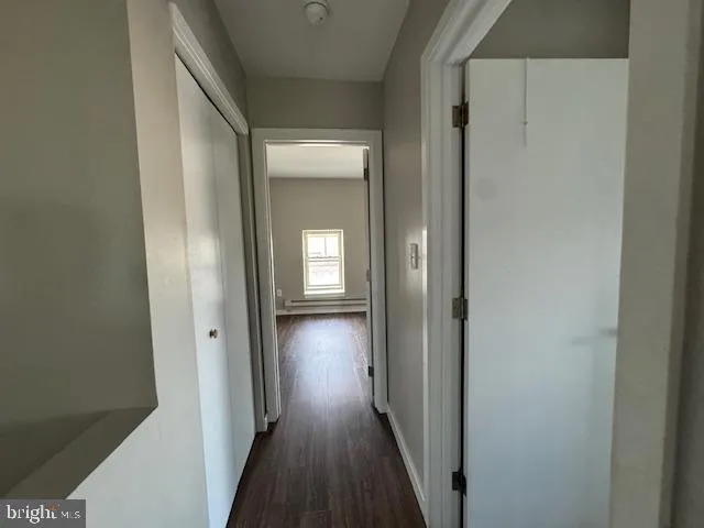 a view of a hallway with wooden floor