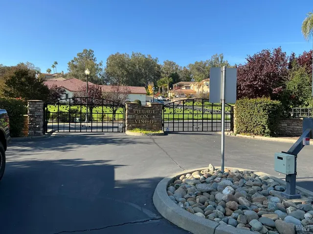 a view of a house with a wooden fence
