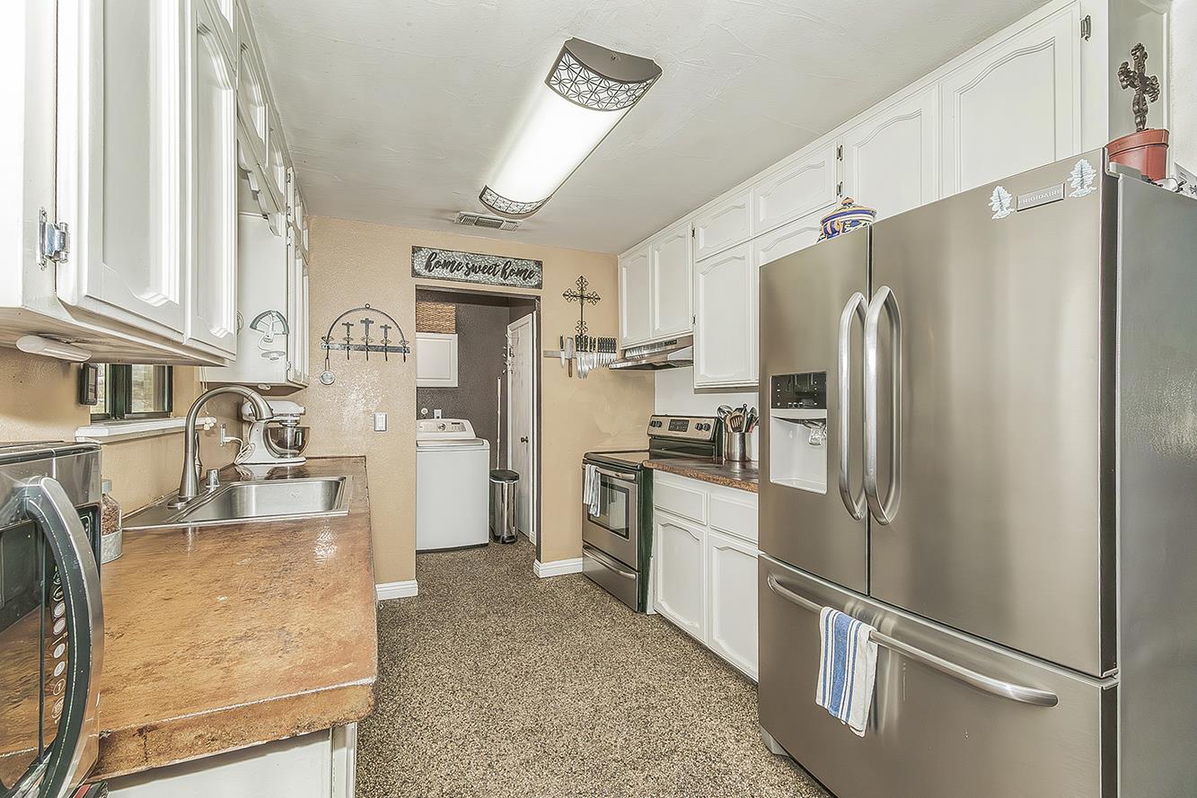 29545 Oak Meadow Road Tollhouse, CA 93667 - Photo 23 of 69 a kitchen with stainless steel appliances granite countertop a refrigerator a stove and a sink