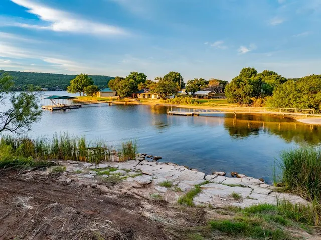 a view of a lake with boats and trees