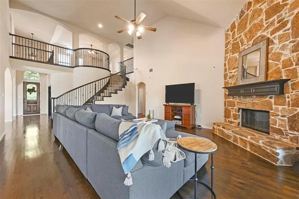 a living room with furniture a fireplace and a flat screen tv