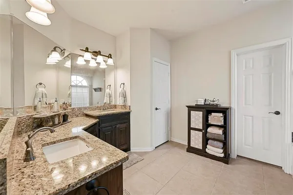 a bathroom with a sink vanity and a mirror