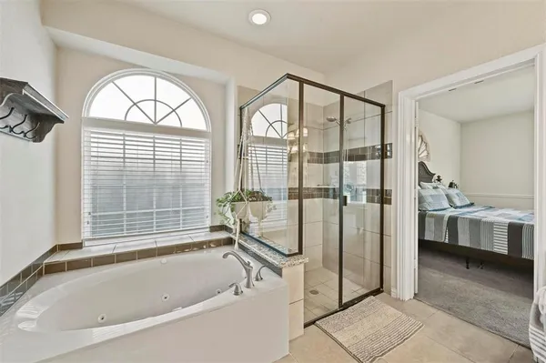 a bathroom with a tub and a view of bathroom