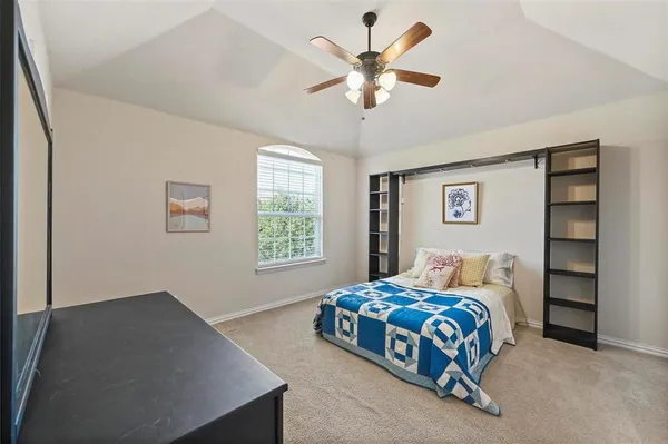 a bedroom with bed and window