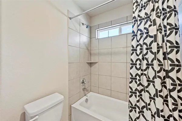 a bathroom with a bathtub and shower