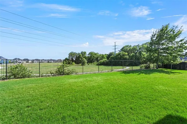 a view of a garden with a building in the background