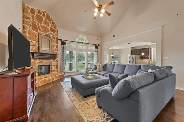 a living room with furniture a flat screen tv and a fireplace