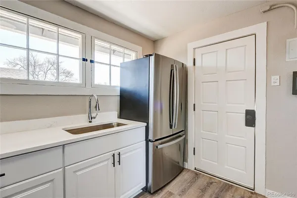 a kitchen with appliances cabinets and a sink