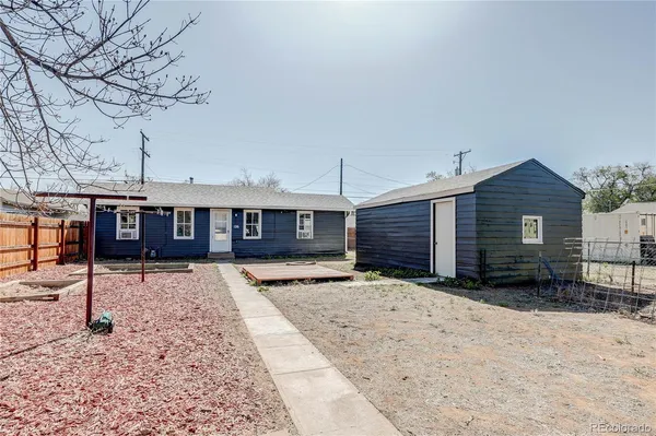 a view of a house with a yard covered in snow