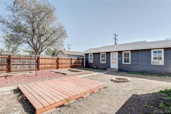 a wooden bench sitting in front of a house
