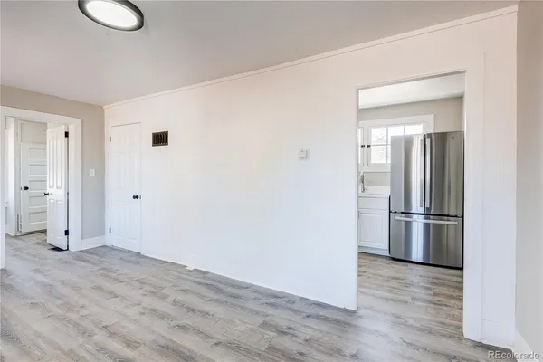 a view of a livingroom with wooden floor and white doors
