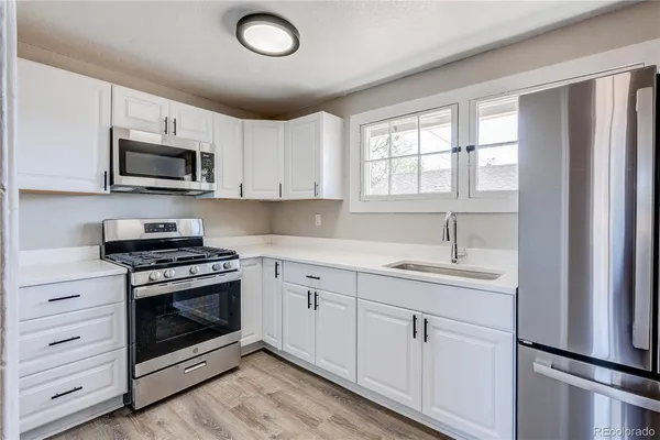 a kitchen with appliances cabinets and a sink