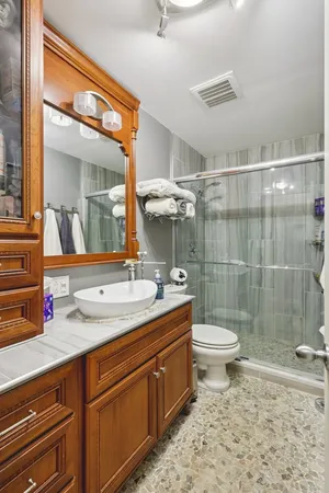 a bathroom with a double vanity sink toilet and shower