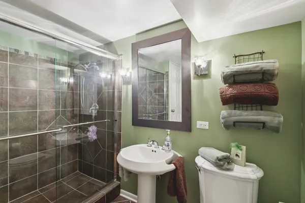 a bathroom with a sink toilet and shower