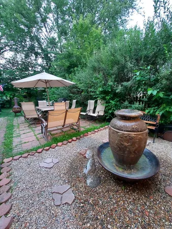 a view of a backyard with table and chairs under an umbrella