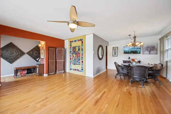 a view of a dining room with furniture and wooden floor