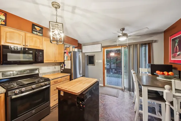 a kitchen with a stove a sink and a refrigerator