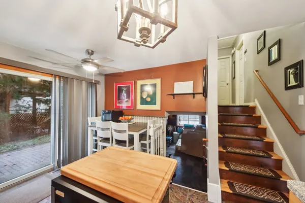 a room with furniture pool table wooden floor and windows