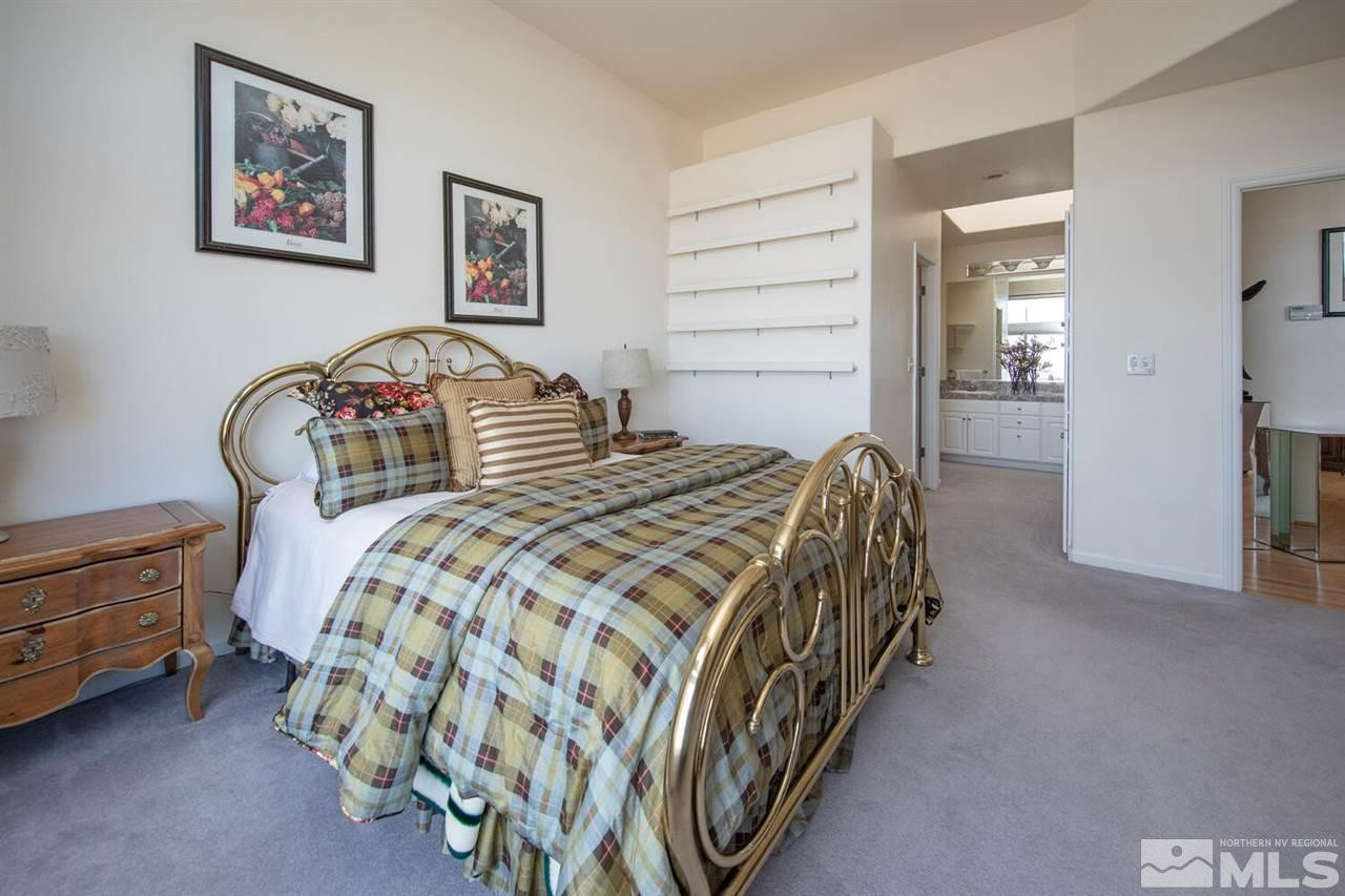 3345 Skyline Boulevard Reno, NV 89509 - Photo 12 of 38 a bedroom with a bed and a lamp on dresser