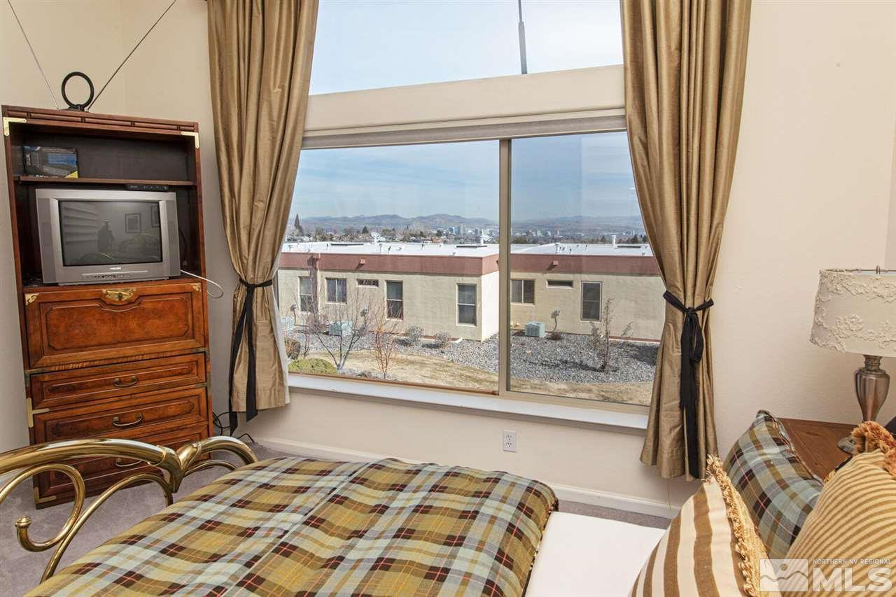 3345 Skyline Boulevard Reno, NV 89509 - Photo 13 of 38 a bedroom with a bed and wooden floor