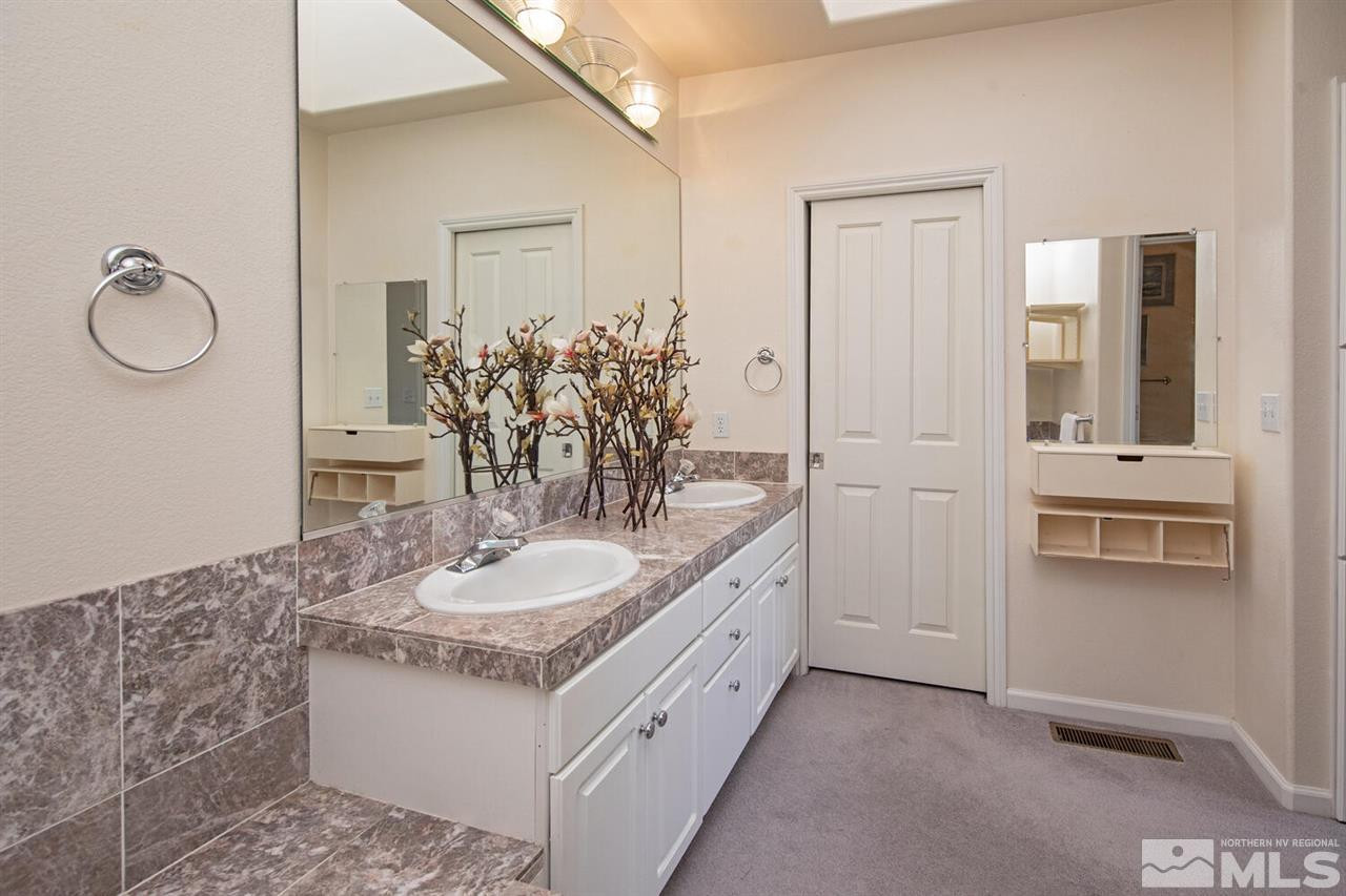 3345 Skyline Boulevard Reno, NV 89509 - Photo 14 of 38 a bathroom with a granite countertop sink and a mirror