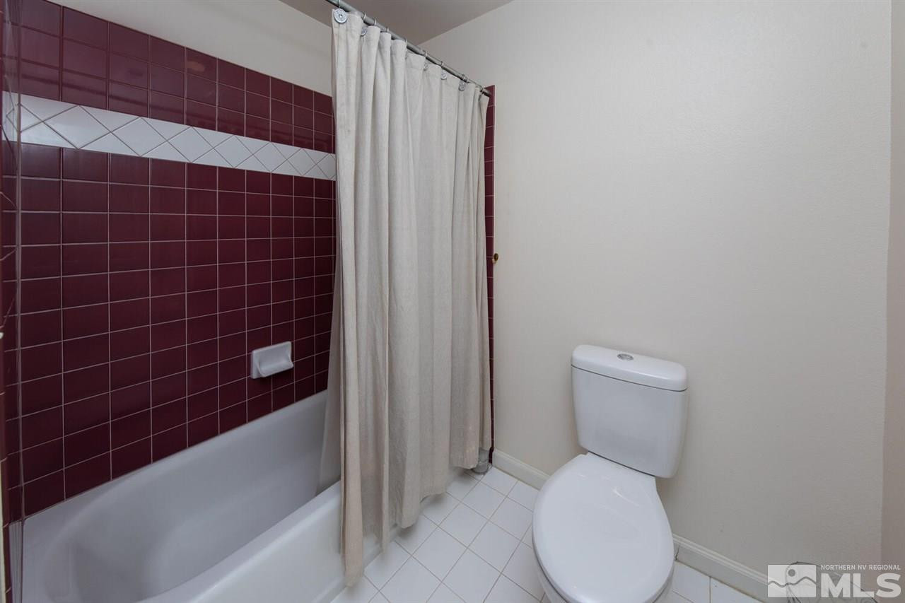 3345 Skyline Boulevard Reno, NV 89509 - Photo 28 of 38 a white toilet sitting next to a bathtub