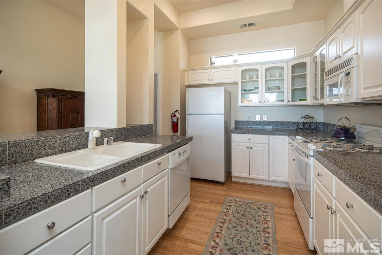 3345 Skyline Boulevard Reno, NV 89509 - Photo 8 of 38 a kitchen with granite countertop a sink stove and refrigerator