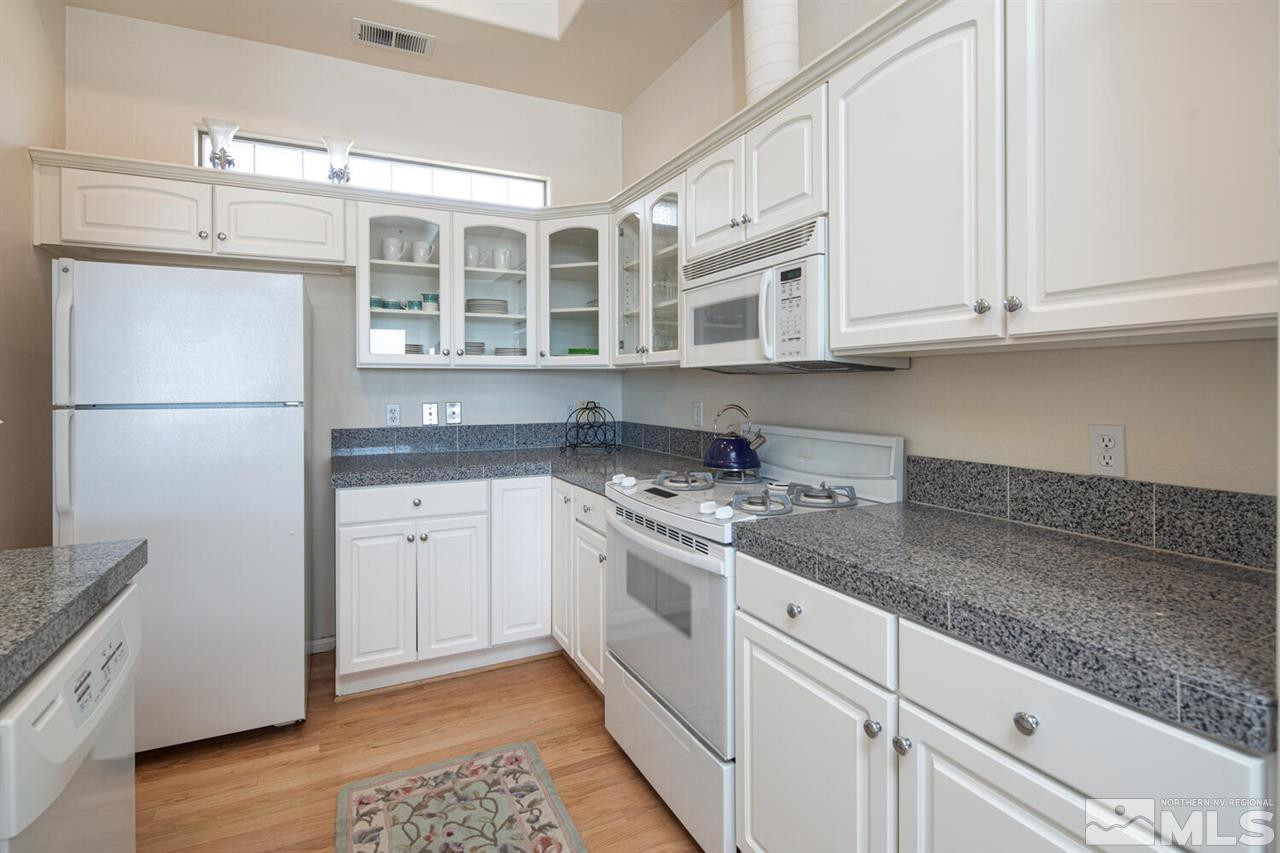 3345 Skyline Boulevard Reno, NV 89509 - Photo 9 of 38 a kitchen with stainless steel appliances granite countertop a refrigerator sink and cabinets