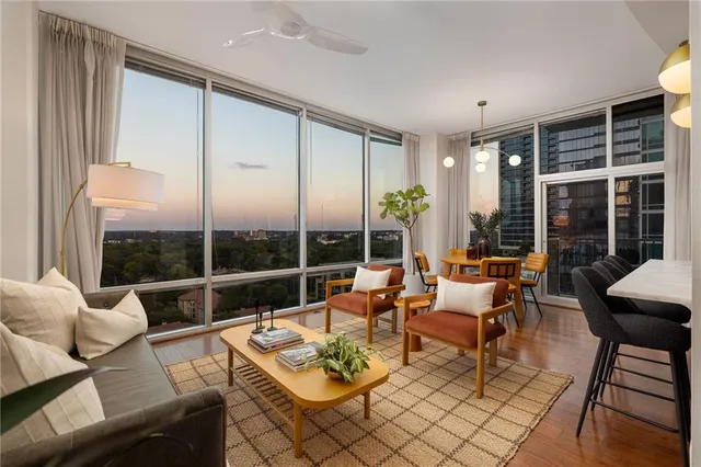 a living room with furniture city view and a large window