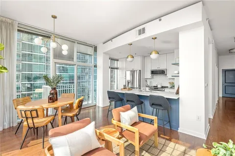 a dining room with wooden floor and large window