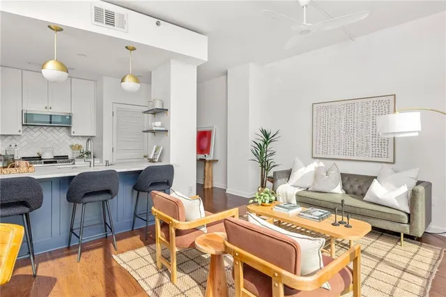 a living room with furniture and a lamp
