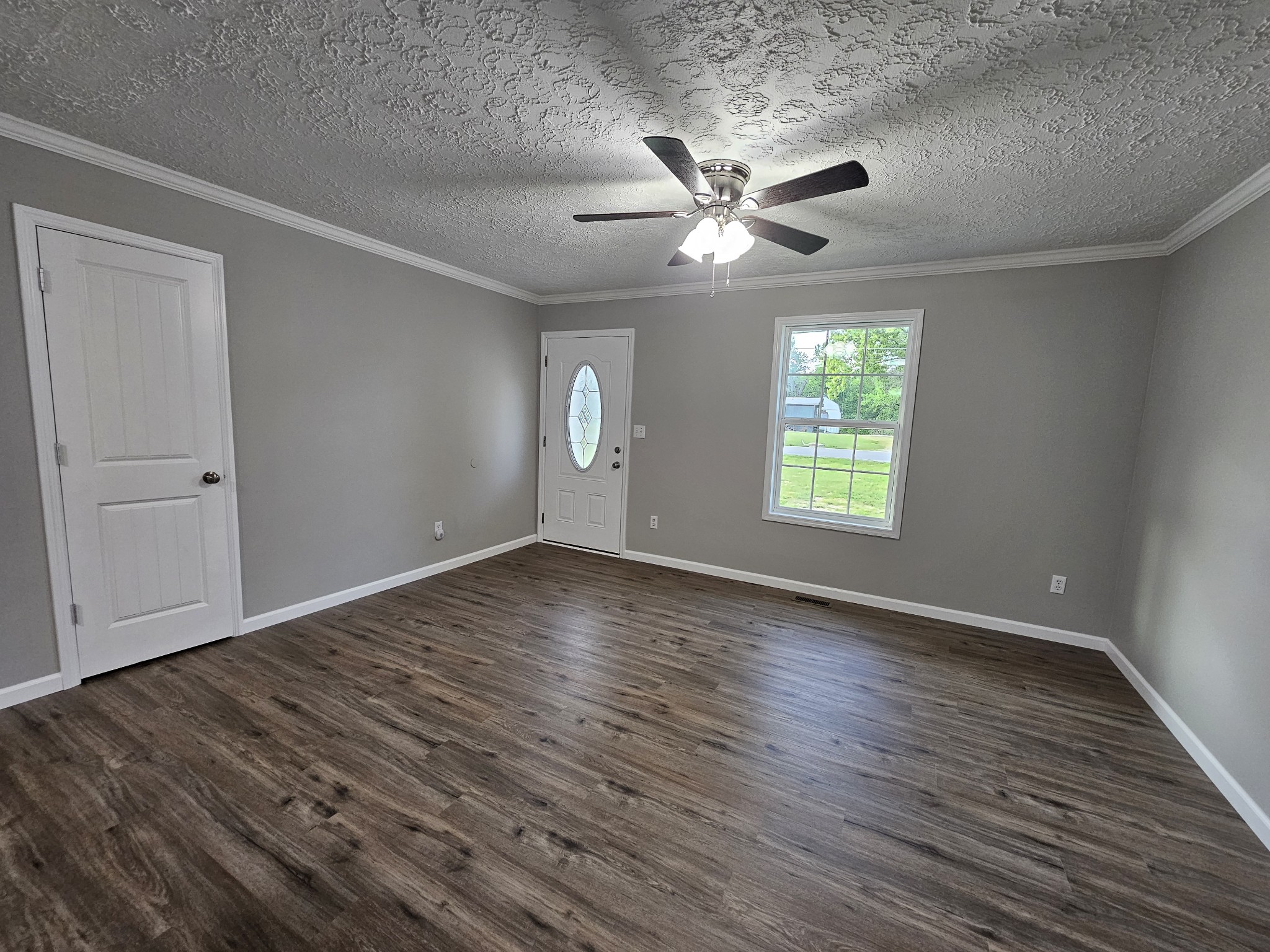 362 Forest Point Road Monteagle, TN 37356 - Photo 22 of 42 an empty room with wooden floor chandelier fan and windows