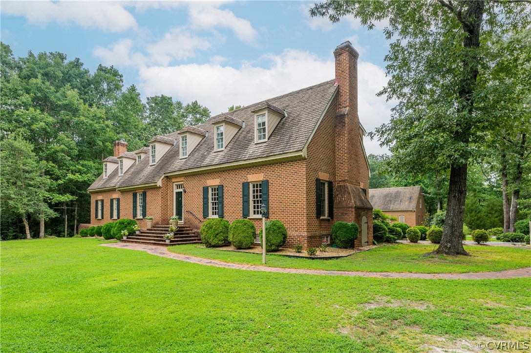 a front view of house with yard and green space