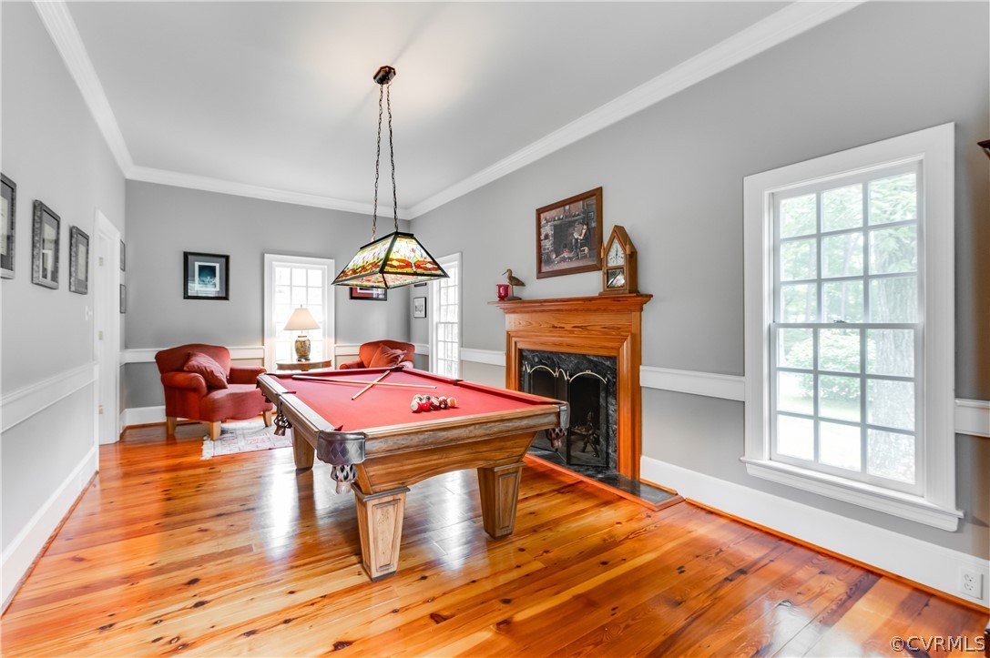 1290 Johns Road Carson, VA 23830 - Photo 14 of 48 a living room with a fireplace with pool table and windows