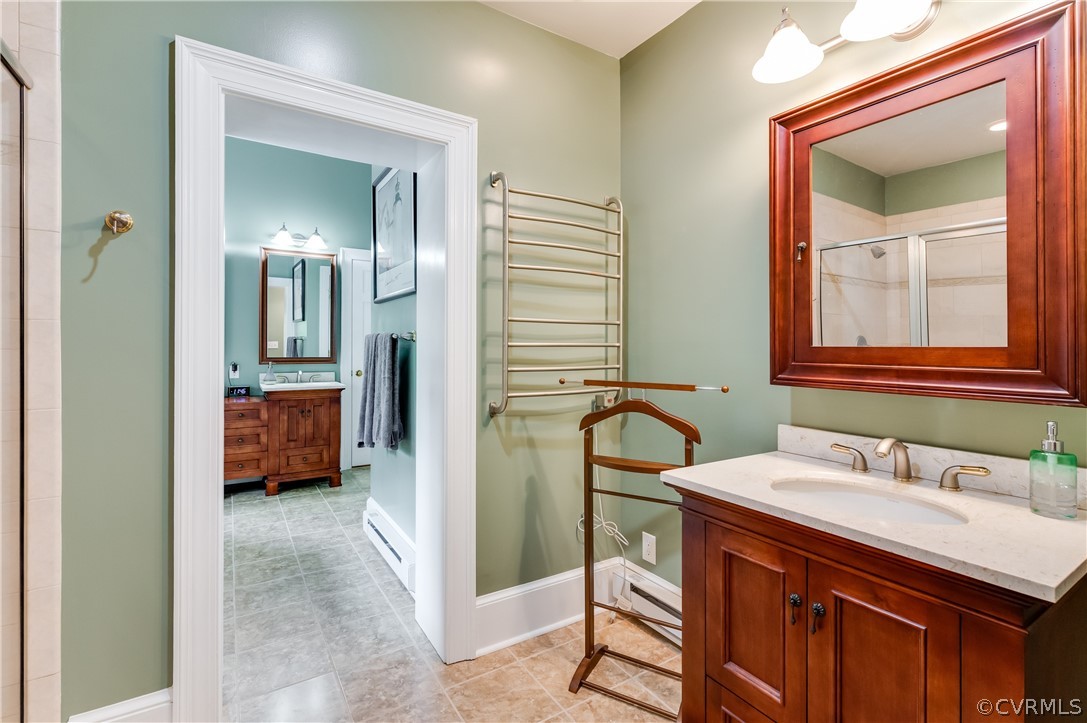 1290 Johns Road Carson, VA 23830 - Photo 22 of 48 a en suite bathroom with a double vanity sink and a mirror