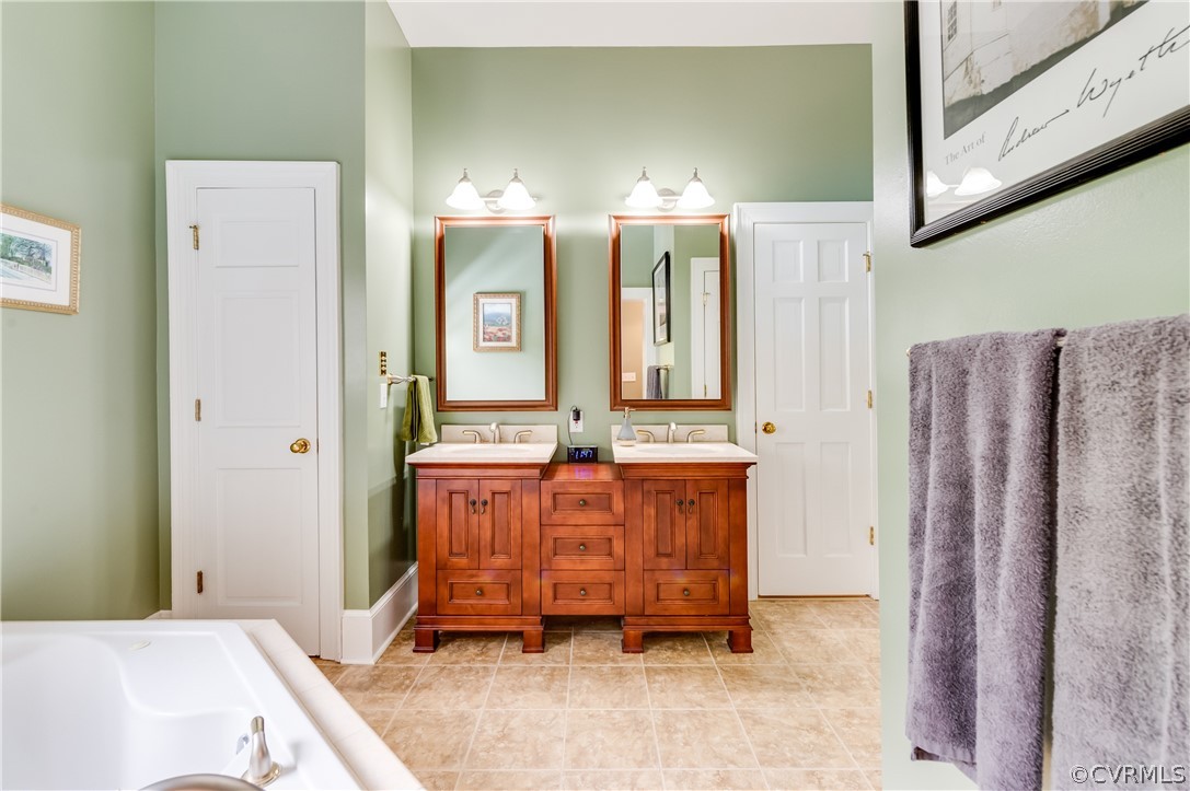 1290 Johns Road Carson, VA 23830 - Photo 24 of 48 a bathroom with a bathtub sink and mirror