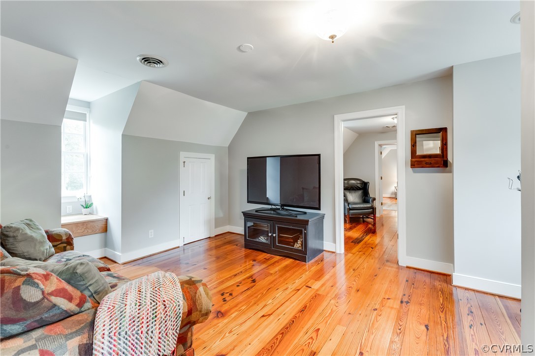 1290 Johns Road Carson, VA 23830 - Photo 27 of 48 a bedroom with a bed and a flat tv screen on dresser