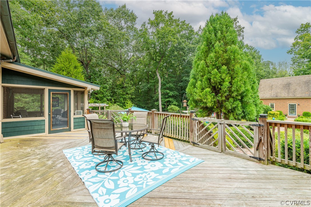 1290 Johns Road Carson, VA 23830 - Photo 35 of 48 a view of a patio with table and chairs and wooden floor