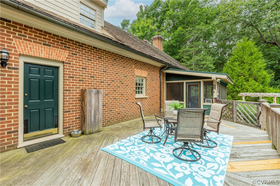 1290 Johns Road Carson, VA 23830 - Photo 36 of 48 a view of a patio with table and chairs and wooden floor