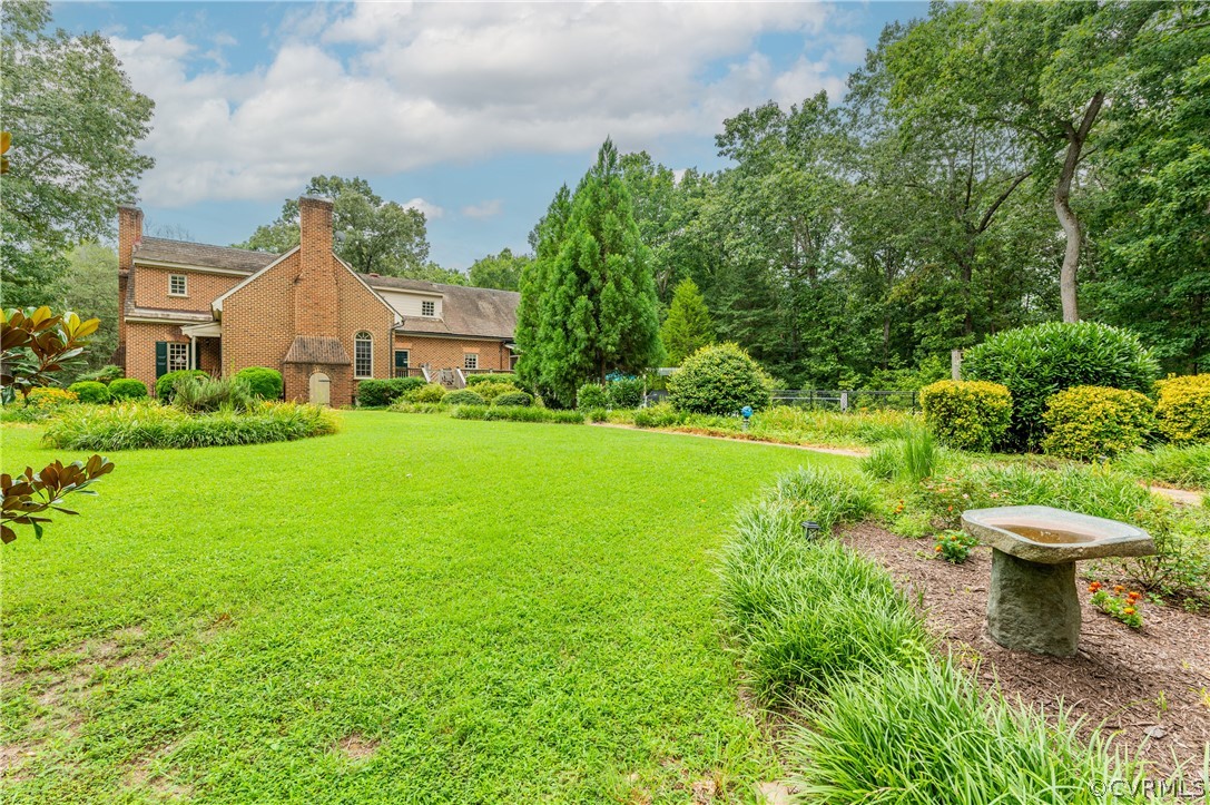 1290 Johns Road Carson, VA 23830 - Photo 43 of 48 a view of a house with a yard and potted plants