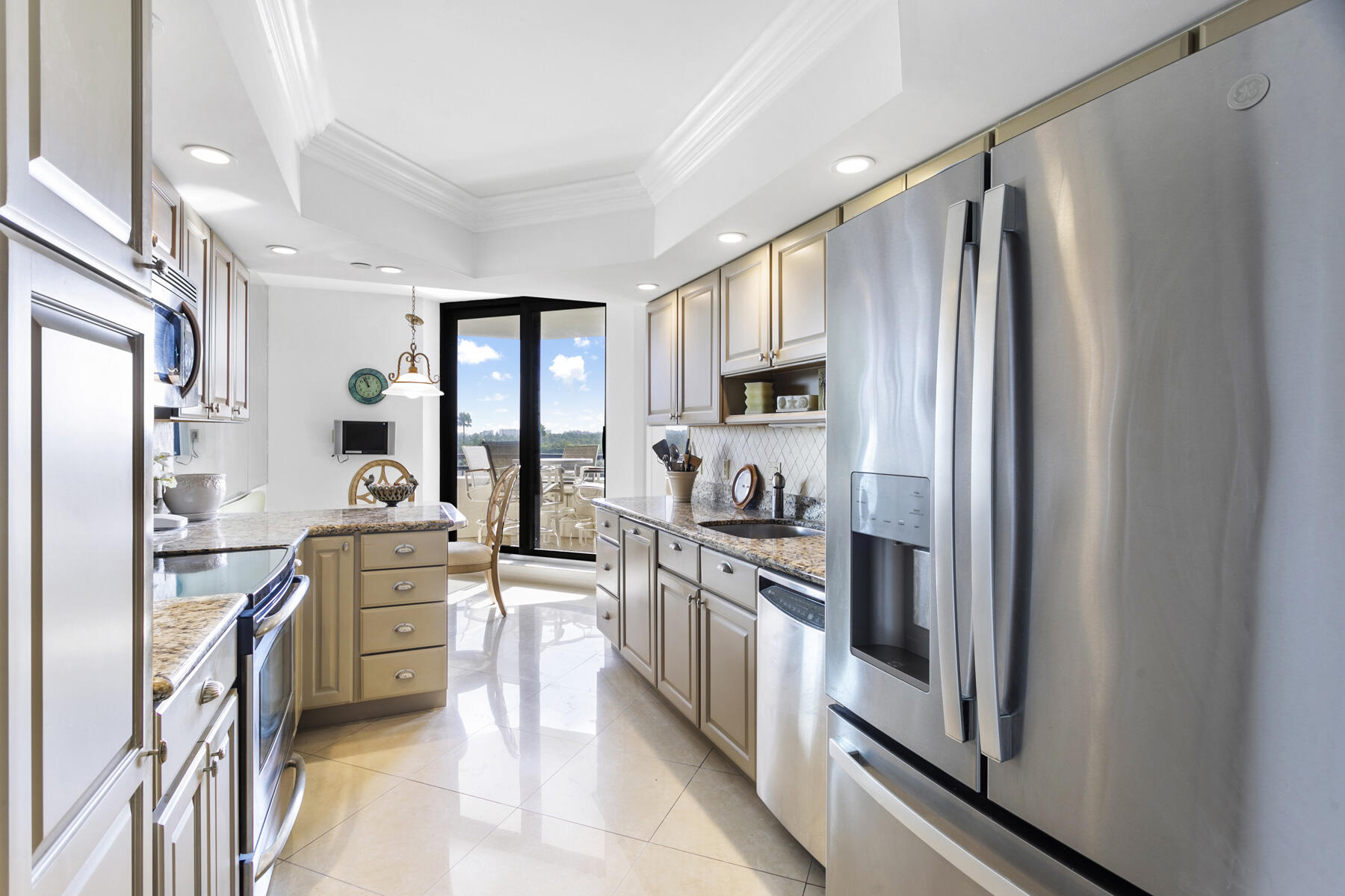 3322 Casseekey Island Road, Unit 504 Jupiter, FL 33477 - Photo 11 of 46 a kitchen with stainless steel appliances a refrigerator stove and sink