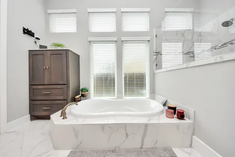 a bathroom with a bathtub and a window