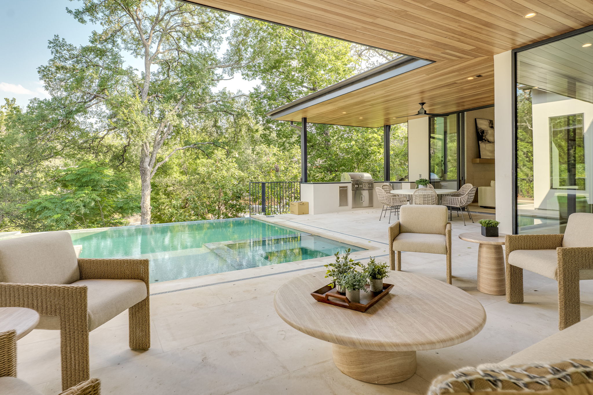 405 Honeycomb Ridge Austin, TX 78746 - Photo 12 of 15 An inviting outdoor living space features a sparkling pool and a sophisticated al fresco dining area, perfect for entertaining.