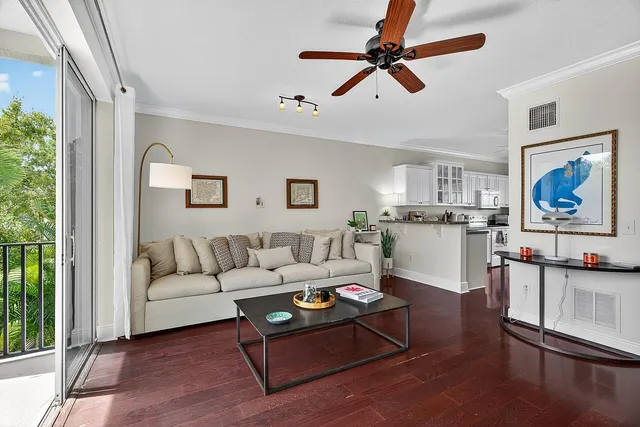 a living room with furniture a rug and a window